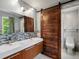 Modern bathroom with double sinks, floating vanity, and stylish barn door at 10978 Roseanna Dr, Northglenn, CO 80234