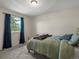 Bedroom with a plush bed, ample natural light, and blue accents at 10978 Roseanna Dr, Northglenn, CO 80234