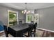 Chic dining room with a large window and stylish chandelier fixture at 10978 Roseanna Dr, Northglenn, CO 80234