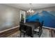 Elegant dining room with mountain-themed mural and stylish chandelier at 10978 Roseanna Dr, Northglenn, CO 80234