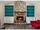 Stone fireplace with built-in shelving flanking the fireplace, and a hardwood floor at 10978 Roseanna Dr, Northglenn, CO 80234