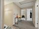 Bright hallway featuring neutral paint, gray carpet, and doorways leading to rooms at 10978 Roseanna Dr, Northglenn, CO 80234