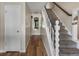 Inviting hallway with hardwood floors, staircase, and neutral decor at 10978 Roseanna Dr, Northglenn, CO 80234