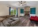 Open living room features a cozy stone fireplace, hardwood floors, and built-in shelving at 10978 Roseanna Dr, Northglenn, CO 80234