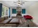 Bright living room features hardwood floors and a cozy stone fireplace with built-in shelving at 10978 Roseanna Dr, Northglenn, CO 80234