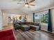 Comfortable living room with hardwood floors and large windows offering backyard views at 10978 Roseanna Dr, Northglenn, CO 80234