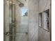 Spa-like shower featuring marble-look tile and recessed shelving at 10978 Roseanna Dr, Northglenn, CO 80234