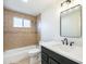 Bathroom featuring newly remodeled tile shower and modern vanity at 2280 Sherrelwood Dr, Denver, CO 80221