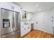 Updated kitchen features stainless steel appliances, white cabinets, and quartz countertops at 2280 Sherrelwood Dr, Denver, CO 80221