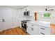 Bright modern kitchen boasts stainless appliances, white cabinets, and sleek hardware at 2280 Sherrelwood Dr, Denver, CO 80221