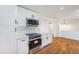 Spacious modern kitchen featuring white cabinetry and stainless steel appliances at 2280 Sherrelwood Dr, Denver, CO 80221