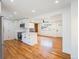 Open-concept living area seamlessly connects the kitchen with hardwood floors throughout at 2280 Sherrelwood Dr, Denver, CO 80221
