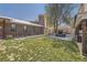 Spacious backyard featuring a modern fireplace, mature trees, and a well-maintained lawn at 3383 S Ogden St, Englewood, CO 80113