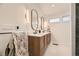 Bright bathroom featuring a double vanity with stylish mirrors, modern lighting, and sleek fixtures at 3383 S Ogden St, Englewood, CO 80113
