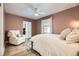 Comfortable bedroom with a plush armchair, ceiling fan, and doorway to an office at 3383 S Ogden St, Englewood, CO 80113
