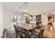 Cozy dining room with a modern table and chairs, opening to a stylish kitchen with an island at 3383 S Ogden St, Englewood, CO 80113