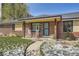 Charming brick home featuring a covered porch with rocking chairs and a well-maintained front yard at 3383 S Ogden St, Englewood, CO 80113