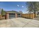 Detached two car garage with modern doors and freshly sealed driveway at 3383 S Ogden St, Englewood, CO 80113