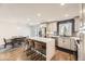 Bright kitchen with a center island, stainless steel appliances, and a dining area for casual meals at 3383 S Ogden St, Englewood, CO 80113