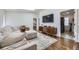Comfortable living room featuring a large sectional sofa, modern media console, and easy access to laundry at 3383 S Ogden St, Englewood, CO 80113