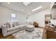 Sunlit living room with a comfortable sofa, skylight, and a view of the surrounding neighborhood at 3383 S Ogden St, Englewood, CO 80113