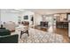 Bright, open-concept living space featuring hardwood floors and seamless flow to the dining and kitchen areas at 3383 S Ogden St, Englewood, CO 80113