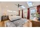 Bright main bedroom featuring skylights, a large window, and ample natural light at 3383 S Ogden St, Englewood, CO 80113