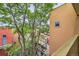 View from balcony with orange building and tree and outdoor staircase at 801 Confidence Dr # 16, Longmont, CO 80504