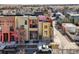 A row of colorful, modern townhomes with balconies and attached garages create a contemporary living space at 801 Confidence Dr # 16, Longmont, CO 80504