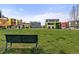 Enjoy the view of the colorful neighborhood buildings from this large green space with a bench at 801 Confidence Dr # 16, Longmont, CO 80504