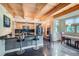 Open kitchen with wood ceiling beams, island with bar stools, and modern appliances at 801 Confidence Dr # 16, Longmont, CO 80504