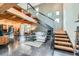 Spacious living room features high ceilings, exposed beams, modern staircase, and comfortable seating area at 801 Confidence Dr # 16, Longmont, CO 80504