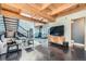 Bright living room with wood beam ceilings, modern furnishings, and open staircase at 801 Confidence Dr # 16, Longmont, CO 80504