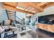 Open living room features exposed wood beams, modern staircase, and a cozy seating area at 801 Confidence Dr # 16, Longmont, CO 80504