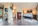 Open main bedroom features a dresser, modern art, and access to the bathroom, blending style and comfort at 801 Confidence Dr # 16, Longmont, CO 80504
