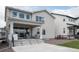 Spacious backyard featuring a covered patio with outdoor kitchen, seating area, and well-manicured lawn at 695 Simmental Loop, Castle Rock, CO 80104