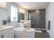 Bright bathroom featuring dual vanities, freestanding tub, and glass-enclosed shower at 695 Simmental Loop, Castle Rock, CO 80104