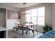 Bright dining area featuring a stylish light fixture, large windows, and modern decor at 695 Simmental Loop, Castle Rock, CO 80104