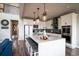 Open-concept kitchen features a large island with bar seating, stainless steel appliances, and lots of natural light at 695 Simmental Loop, Castle Rock, CO 80104