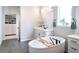 Bathroom featuring a soaking tub, large mirror, and a walk-in closet with ample storage at 695 Simmental Loop, Castle Rock, CO 80104