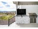 Outdoor kitchen with stainless steel grill, granite countertop and outdoor TV overlooking the beautiful scenery at 695 Simmental Loop, Castle Rock, CO 80104