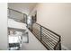 Elegant staircase with modern metal railings and carpeted steps, leading to upper level at 695 Simmental Loop, Castle Rock, CO 80104