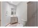 This bathroom features a vanity with a sink, a commode, and a grey closet at 14440 Eagle Vista Dr, Littleton, CO 80127