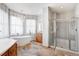 Bright bathroom with soaking tub, shower and tile floors at 14440 Eagle Vista Dr, Littleton, CO 80127
