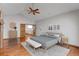 This main bedroom includes a ceiling fan, hardwood floors, and multiple wood doors at 14440 Eagle Vista Dr, Littleton, CO 80127