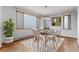 Bright dining room with modern lighting, a geometric rug, and large windows at 14440 Eagle Vista Dr, Littleton, CO 80127
