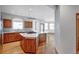 Spacious kitchen features wood cabinets, stainless steel appliances, and a large island with cooktop at 14440 Eagle Vista Dr, Littleton, CO 80127