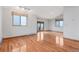 Spacious living room featuring wood floors, two windows and a set of french doors at 14440 Eagle Vista Dr, Littleton, CO 80127