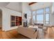 Bright living room with vaulted ceilings, wood floors, fireplace, and large windows at 14440 Eagle Vista Dr, Littleton, CO 80127