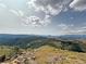 A stunning vista of green fields and forests can be seen in this picture at 14440 Eagle Vista Dr, Littleton, CO 80127